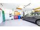 Attached two car garage with workbench, storage, and painted floors at 4313 Brooke Dr, Valrico, FL 33594