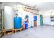 Spacious garage featuring water storage and water softener system, plus a coated floor at 4313 Brooke Dr, Valrico, FL 33594