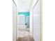 Bright hallway with carpet and view into an aqua bathroom with soaking tub and shower at 4313 Brooke Dr, Valrico, FL 33594