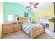 Bright main bedroom with king bed, tropical colors and decor, and backyard patio access at 4313 Brooke Dr, Valrico, FL 33594
