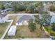A birds eye view of a house with a large backyard, mature trees and a storage shed at 4350 Talco Ave, Spring Hill, FL 34609