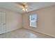 Bright bedroom featuring neutral paint, tiled floors, and a ceiling fan at 4350 Talco Ave, Spring Hill, FL 34609
