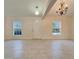 Spacious living room featuring tiled floors, pendant lighting, and large windows at 4350 Talco Ave, Spring Hill, FL 34609
