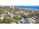 Aerial view of a waterfront property with lush landscaping and city views, surrounded by mature trees at 4603 S Bartlett St, Tampa, FL 33611