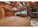 Spacious attic featuring wood framing, plywood flooring, and a large HVAC system for optimal climate control and storage at 4603 S Bartlett St, Tampa, FL 33611