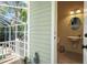 Well-lit bathroom featuring a sink and mirror, accessible from the screened-in pool area at 4603 S Bartlett St, Tampa, FL 33611