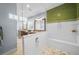 Bathroom featuring a large glass shower with green tiled walls, dual granite vanities at 4603 S Bartlett St, Tampa, FL 33611
