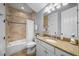 Bathroom featuring a vanity with granite countertop, toilet, shower over tub and tiled floors at 4603 S Bartlett St, Tampa, FL 33611