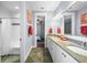Well-lit bathroom with double sinks, granite countertops, and a shower, creating a spa-like experience at 4603 S Bartlett St, Tampa, FL 33611