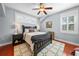 Cozy bedroom with a ceiling fan, natural light, and a comfortable queen size bed at 4603 S Bartlett St, Tampa, FL 33611