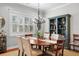 Dining room with hardwood floors, a modern chandelier, and built-in bar with shelving at 4603 S Bartlett St, Tampa, FL 33611