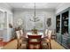 Dining room with hardwood floors, a modern chandelier, and built-in bar with shelving at 4603 S Bartlett St, Tampa, FL 33611