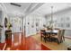Open-concept dining room with hardwood floors, neutral decor, and a view to the entry way at 4603 S Bartlett St, Tampa, FL 33611