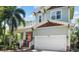 Charming two-story home featuring a well-manicured lawn, two-car garage, and inviting front porch at 4603 S Bartlett St, Tampa, FL 33611