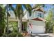 Inviting two-story home featuring a well-manicured lawn, two-car garage, and inviting front porch at 4603 S Bartlett St, Tampa, FL 33611