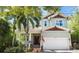 Charming two-story home with manicured lawn, palm trees, brick-paved walkway, and inviting front porch at 4603 S Bartlett St, Tampa, FL 33611