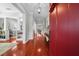 Hallway with red door, beautiful hardwood floors, and a view into the open floor plan at 4603 S Bartlett St, Tampa, FL 33611