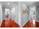 Long hallway with wood floors and access to other rooms at 4603 S Bartlett St, Tampa, FL 33611