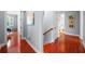 Bright hallway with beautiful hardwood floors and neutral paint, leading to bedrooms and a bathroom at 4603 S Bartlett St, Tampa, FL 33611