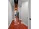 Hallway with pull down attic access, hardwood floors, and neutral paint, providing access to additional storage at 4603 S Bartlett St, Tampa, FL 33611