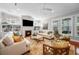 Inviting living room with a fireplace, built-in bookshelves, comfortable seating, and natural light at 4603 S Bartlett St, Tampa, FL 33611