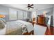 A luxurious main bedroom with wood floors, ceiling fan, and access to the bathroom at 4603 S Bartlett St, Tampa, FL 33611