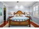 A spacious main bedroom with wood floors, ceiling fan, and walk-in closets at 4603 S Bartlett St, Tampa, FL 33611