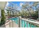 Stunning screened-in pool area with a spa, fire pit, and lush landscaping at 4603 S Bartlett St, Tampa, FL 33611