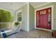 Cozy front porch with brick flooring, rocking chairs, and a 'welcome' mat, great for relaxing at 4603 S Bartlett St, Tampa, FL 33611