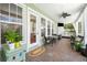 Inviting screened porch with outdoor seating, a ceiling fan, and views of the surrounding greenery at 4603 S Bartlett St, Tampa, FL 33611