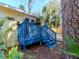 A cozy blue deck perfect for relaxing in the shade, surrounded by lush green foliage at 5029 29Th S Ave, Gulfport, FL 33707