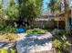 Beautifully landscaped backyard with winding stone pathways, mature trees, and a charming fence for added privacy at 5029 29Th S Ave, Gulfport, FL 33707