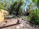 A secluded backyard featuring mature trees, a hammock, stone pavers, and a wood fence at 5029 29Th S Ave, Gulfport, FL 33707