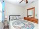 Bright bedroom with a wooden dresser, ceiling fan, and window with natural light at 5029 29Th S Ave, Gulfport, FL 33707