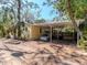 Home exterior featuring a covered carport and driveway with mature landscaping at 5029 29Th S Ave, Gulfport, FL 33707