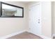 Bright entryway with laminate flooring, white door, and a large decorative mirror at 5029 29Th S Ave, Gulfport, FL 33707