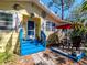 Close up of the front of the home displaying the blue stairs, decorations and outdoor seating area at 5029 29Th S Ave, Gulfport, FL 33707