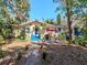 Charming single-Gathering home with a colorful exterior, blue stairs, and a cozy patio seating area at 5029 29Th S Ave, Gulfport, FL 33707