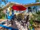 Home's front yard featuring a red umbrella over a table with chairs at 5029 29Th S Ave, Gulfport, FL 33707