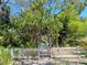 Welcoming white picket fence and arbor leading to a charming home with lush greenery at 5029 29Th S Ave, Gulfport, FL 33707