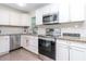 Well-lit kitchen with stainless steel appliances, white cabinets, and granite countertops at 5029 29Th S Ave, Gulfport, FL 33707
