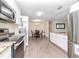 Open kitchen leading to a dining area with modern appliances and light wood-look flooring at 5029 29Th S Ave, Gulfport, FL 33707