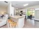 Open-concept kitchen view with bar stool seating, white cabinets, and seamless transition to the living area at 5029 29Th S Ave, Gulfport, FL 33707