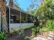 Inviting screened porch attached to the home, offering a relaxing outdoor living space surrounded by lush greenery at 5029 29Th S Ave, Gulfport, FL 33707