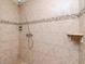 Walk-in shower featuring a rainfall shower head and neutral tile at 5029 29Th S Ave, Gulfport, FL 33707
