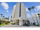 Modern high-rise condominium building with palm trees and well-maintained landscaping at 5940 Pelican Bay S Plz # 1205, Gulfport, FL 33707