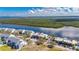 Aerial view featuring the condominium complex surrounded by trees and waterways at 611 Destiny Dr # 304, Ruskin, FL 33570