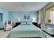 Inviting bedroom with Beach House decor, featuring a comfortable recliner and a queen bed at 611 Destiny Dr # 304, Ruskin, FL 33570