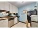Efficient kitchen featuring white cabinets, modern appliances, and a cozy dining area, ideal for preparing delicious meals at 611 Destiny Dr # 304, Ruskin, FL 33570