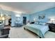 Stylish main bedroom featuring modern decor, tiled floors, and beach-themed accents, complete with a comfortable queen bed at 611 Destiny Dr # 304, Ruskin, FL 33570